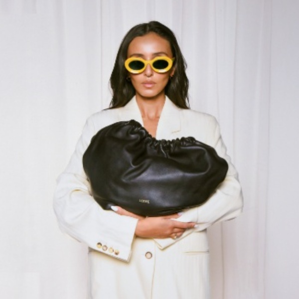 Image of a model in with luxury bag
